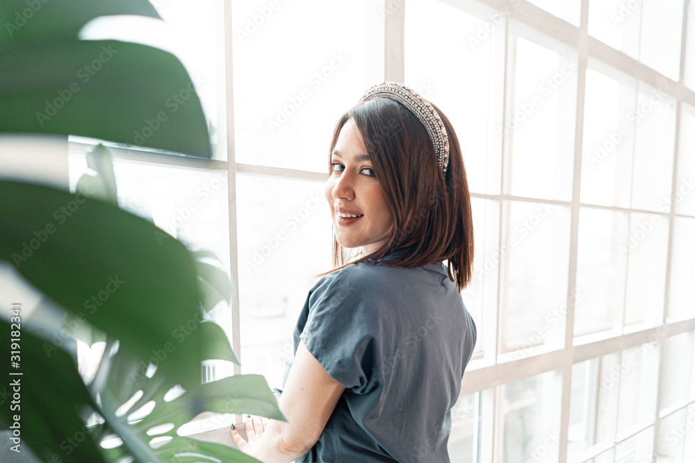 Attractive Woman Smiling Near Big Window Filled With Morning Sunlight. Good Morning, Motivation To Begin New Happy Life