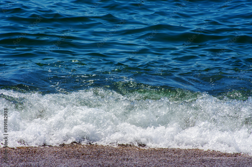 Fototapeta premium Wave of the sea on the sand beach