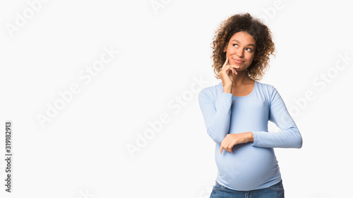 Pregnant woman dreaming, imagining motherhood life, free space