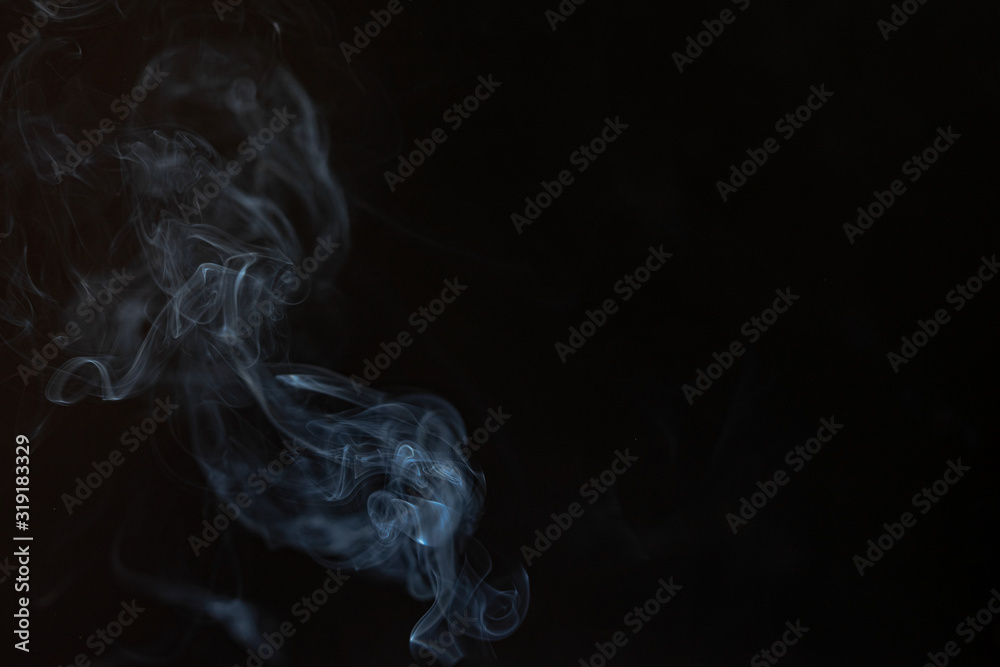 Abstract smoke from incense and light in a black background Abstract smoke from incense and light in a black background