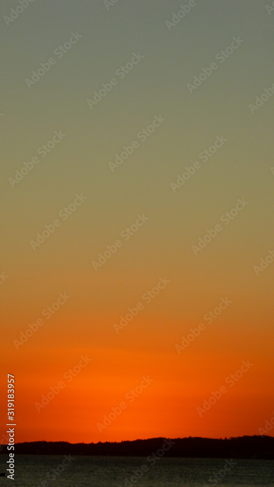 Minimalist photography with dramatic orange sky during twilight