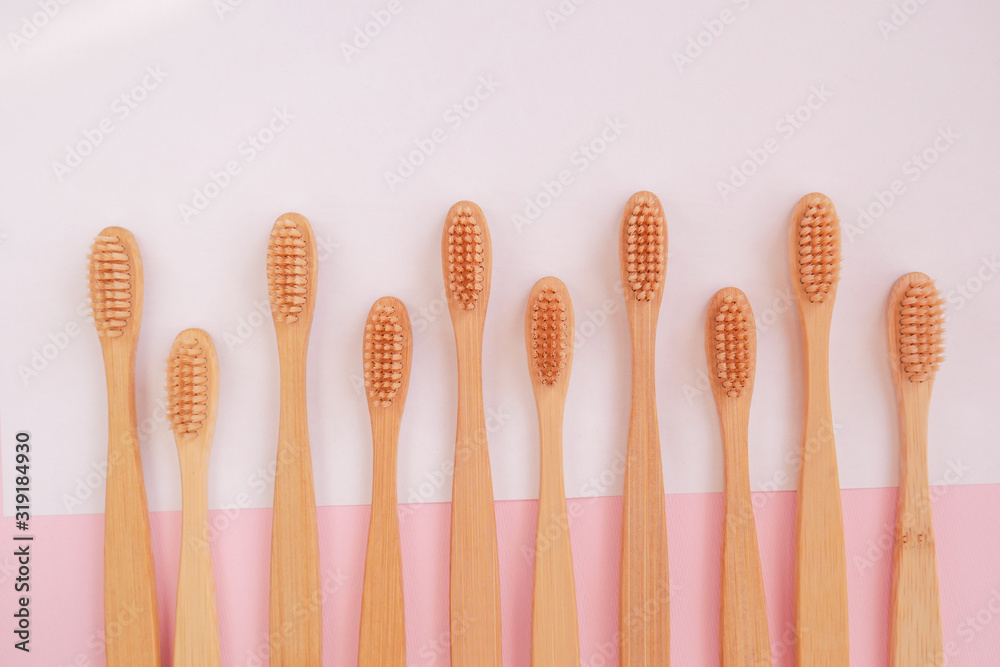wooden bamboo toothbrushes on white and pink background wooden bamboo toothbrushes on white and pink background