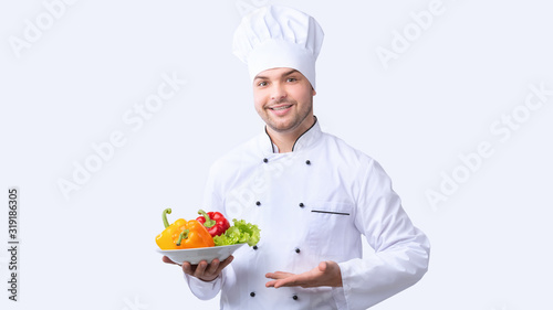 Chef Man Holding Plate With Vegetables Standing, Studio Shot, Panorama