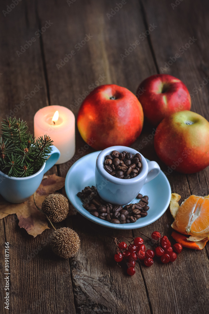 cup with coffee grains and fruits on a wooden background..