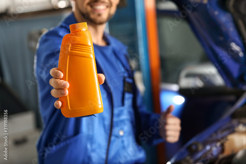 Male mechanic with bottle o...