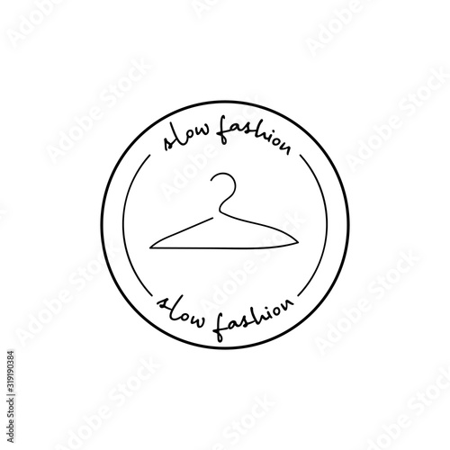 Minimalistic badge with hanger and handdrawn inscription slow fashion. Design element for packaging design and promotional material. Vector illustration.