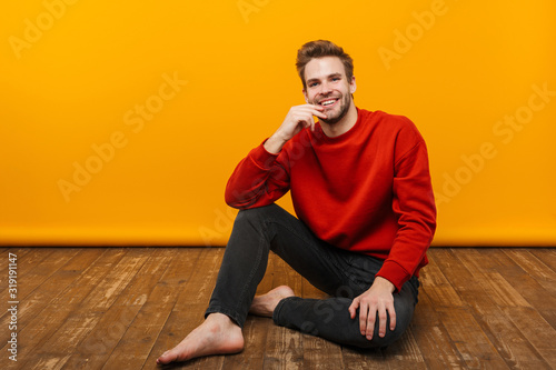 Attractive happy young man wearing pullower photo