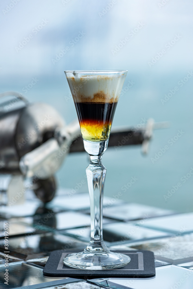 Hot Shot cocktail on a light sparkling background. Hot Shot cocktail on a light sparkling background.