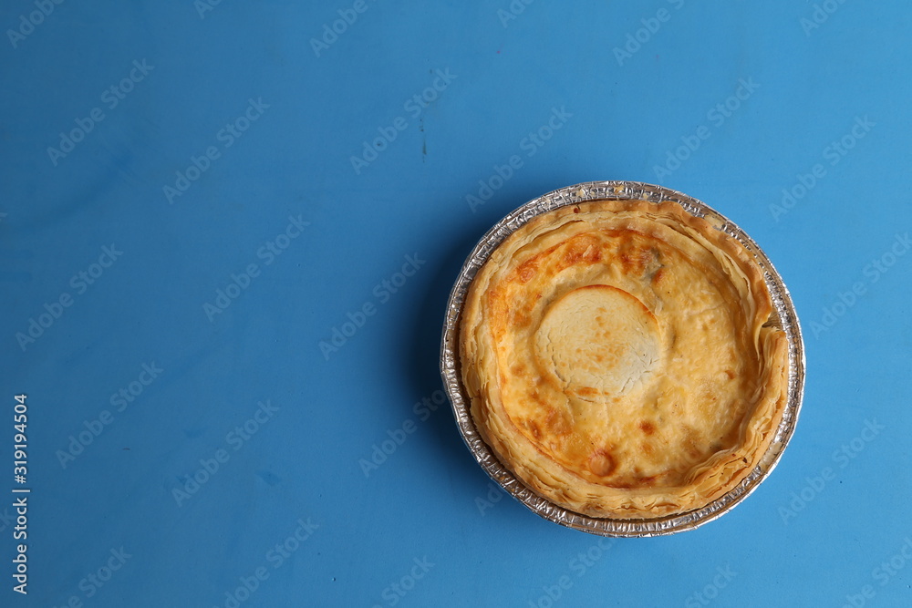 Delicious three cheese quiche in colored background Delicious three cheese quiche in colored background