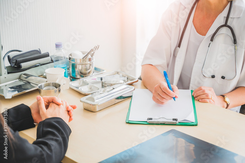 Senior female doctor meet the patient discussing and making notes about symptom problem. Health care and client service in medicine concept.