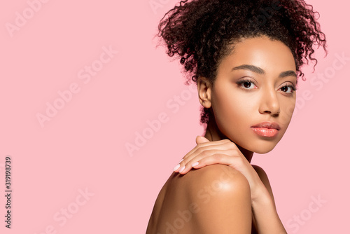 portrait of nude african american girl with clean face, isolated on pink