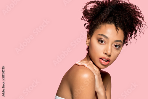 portrait of naked african american girl with clean face, isolated on pink
