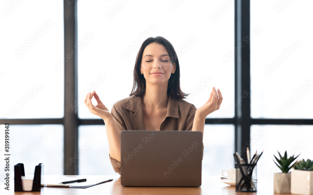 Girl meditating in office coping with stress - obrazy, fototapety, plakaty 