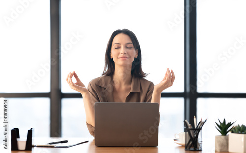 Girl meditating in office coping with stress