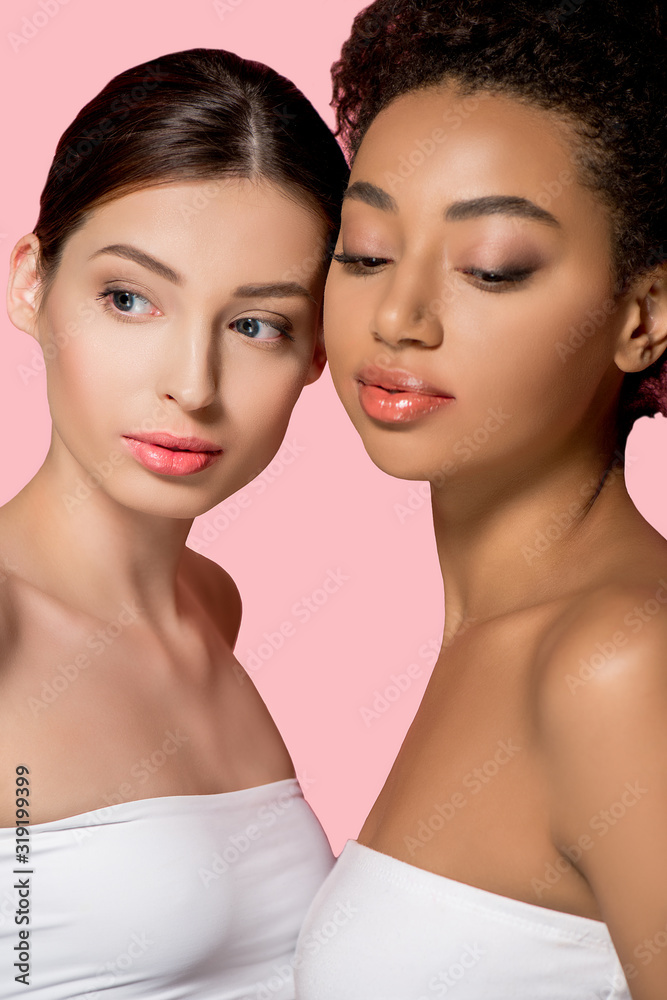 portrait of multiracial girls with perfect skin, isolated on pink portrait of multiracial girls with perfect skin, isolated on pink