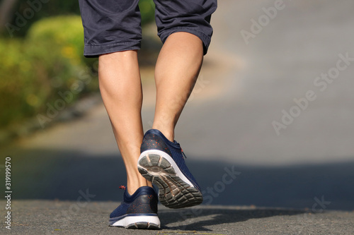 Foot of back men jogger outdoor  in the park lifestyle for exercise in morning good healthy protect body from influenza