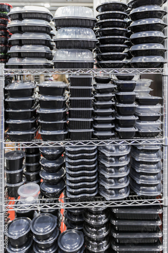 Plastic black containers with a transparent lid, stacked empty food containers