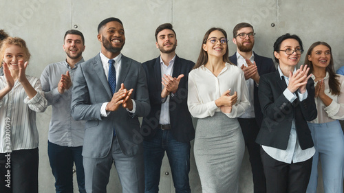 Diverse business colleagues clapping hands after meeting photo
