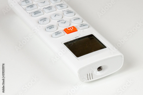 air conditioning remote control, white plastic cover with colored button and white buttons, for switching the device on and off, remote control of functions, range