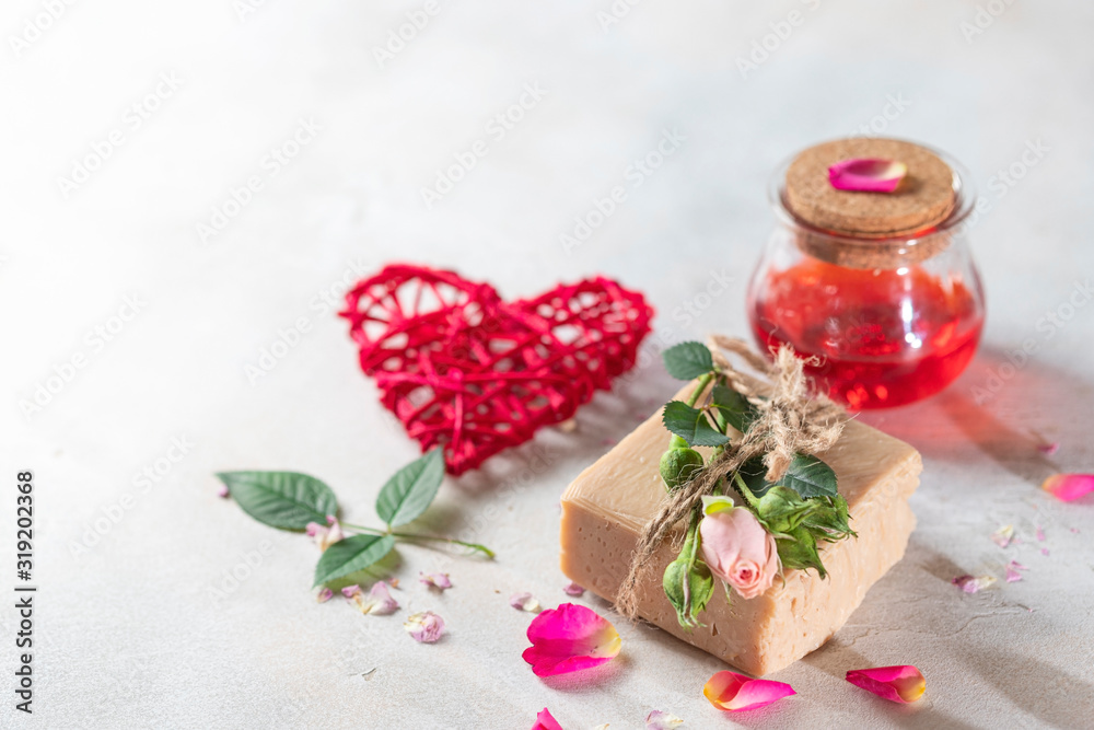 Organic handmade soap, pink rose bud on a white concrete background. Natural and non-waste cosmetic ingredients. Healthy lifestyle concept. Organic handmade soap, pink rose bud on a white concrete background. Natural and non-waste cosmetic ingredients. Healthy lifestyle concept.