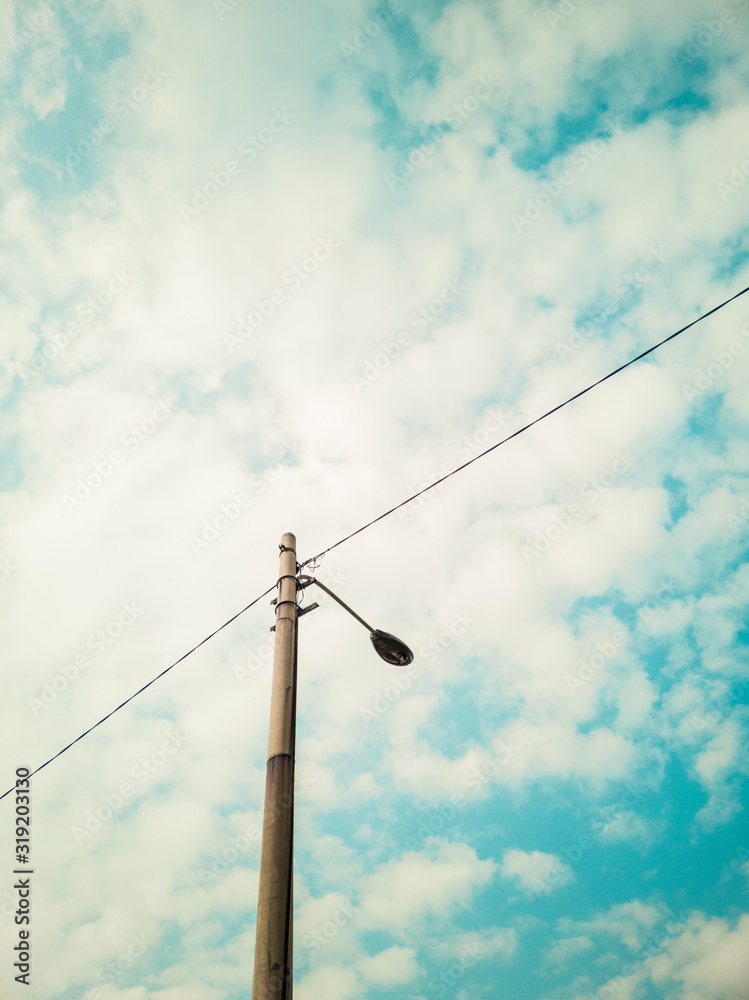 An old electric pole on blue sky