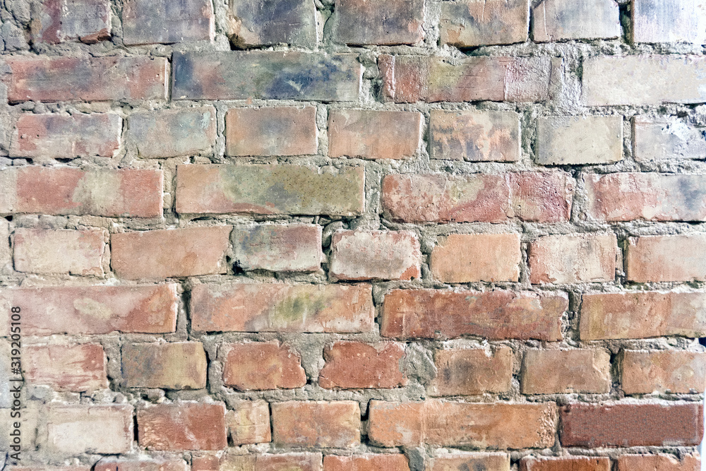 Dirty brick wall with spots and stains, old decorative wall Dirty brick wall with spots and stains, old decorative wall