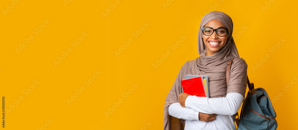 Portrait of black girl student in headscarf with backpack and notepads - obrazy, fototapety, plakaty 