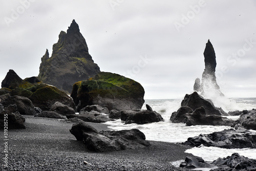 The waves are washed up on stones of the black beach in Vik region, Iceland.