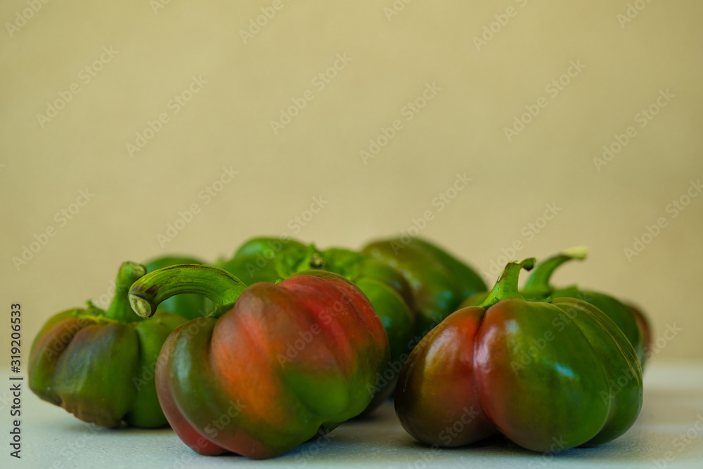Raw ripe green organic bell peppers ready in a plate