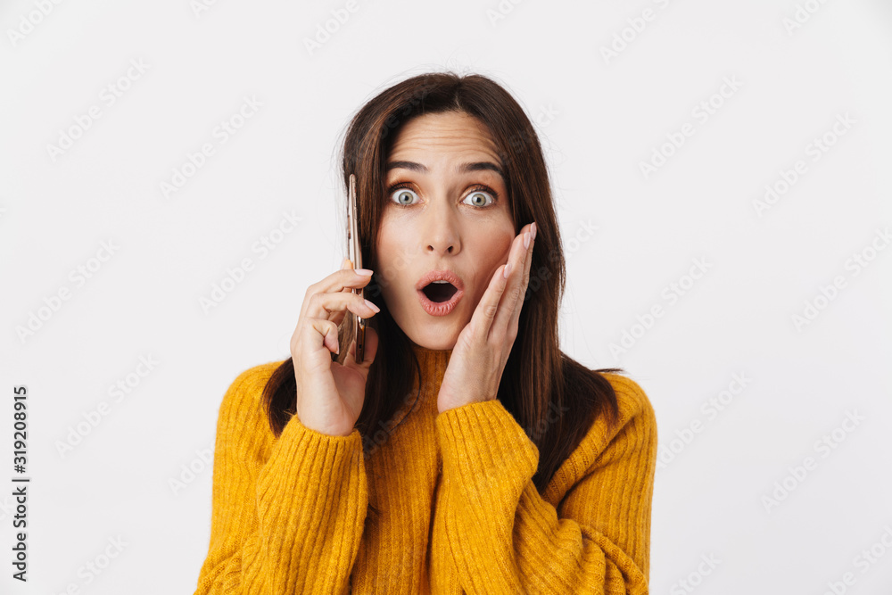 Image of beautiful brunette adult woman wondering and talking on cellphone Image of beautiful brunette adult woman wondering and talking on cellphone