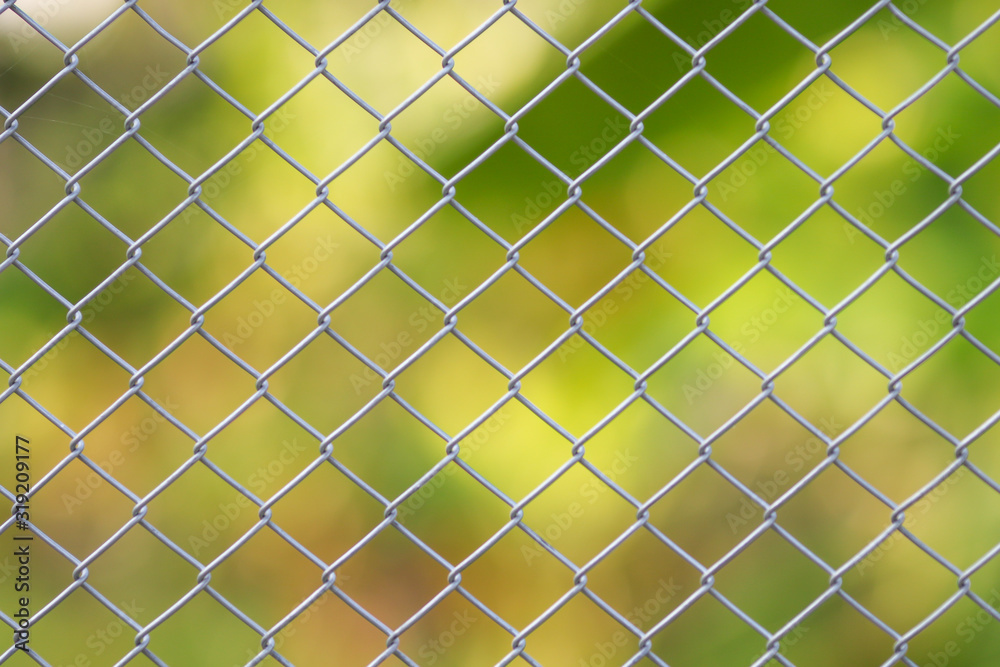 Fototapeta premium Steel fence wall with green nature background