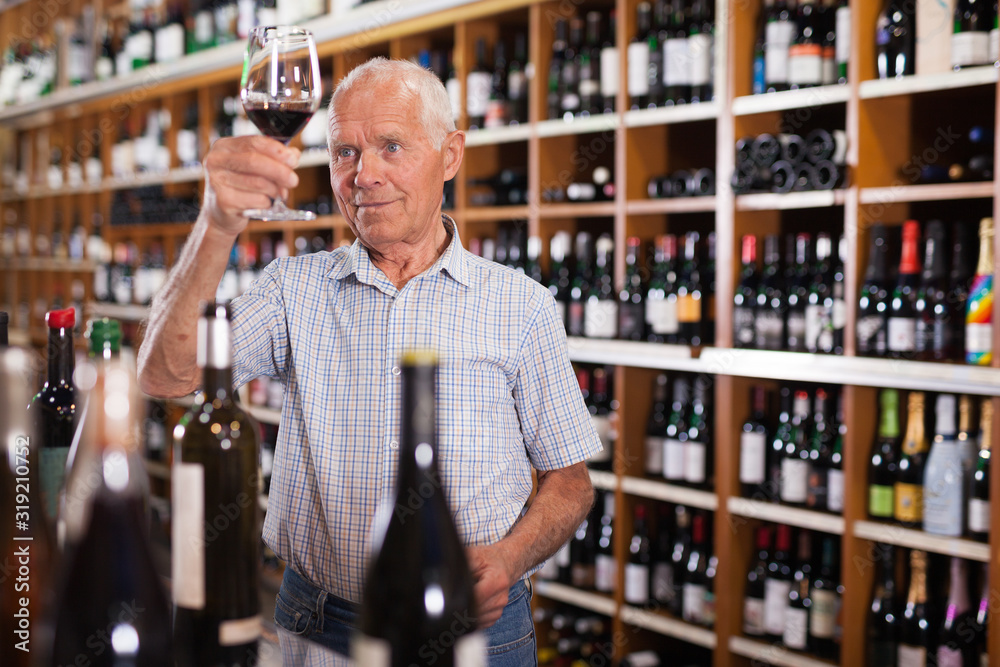 Man inspecting wine in wine store