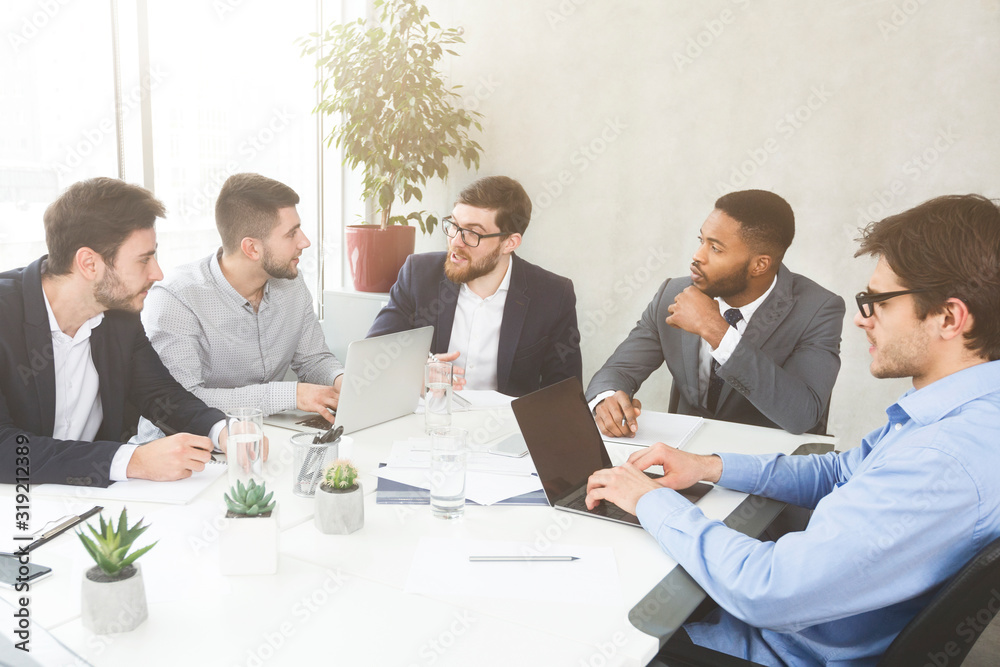 Fototapeta premium Businessmen having group meeting, discussing new project