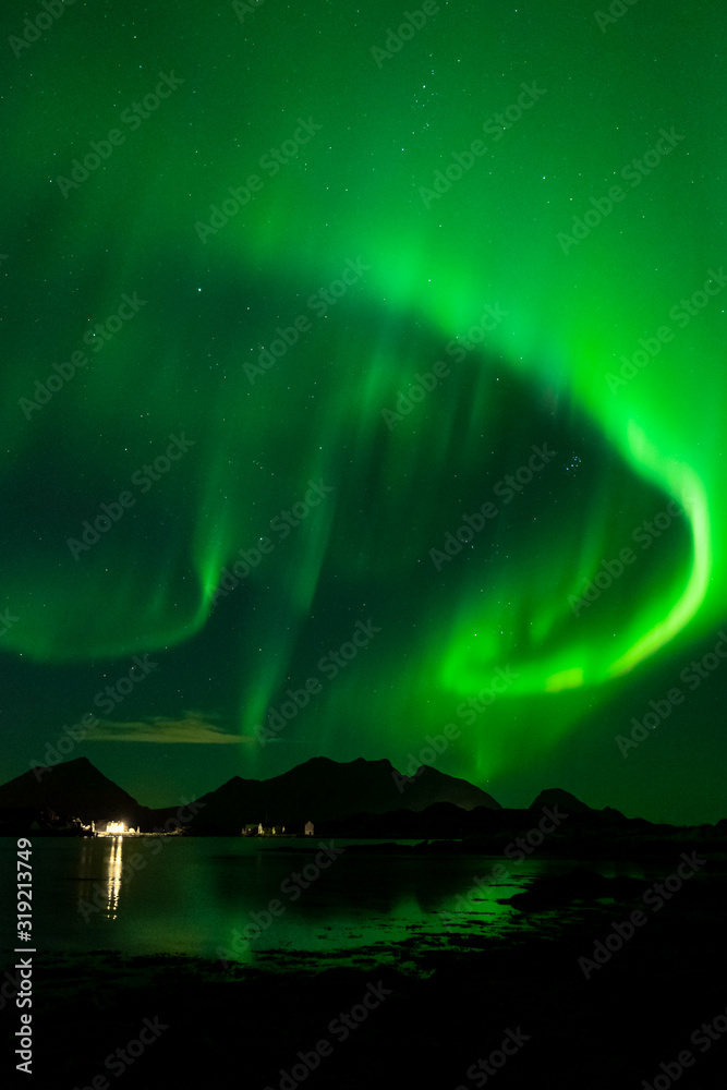 Northern lights in norway. reflection of aurora borealis in the sea