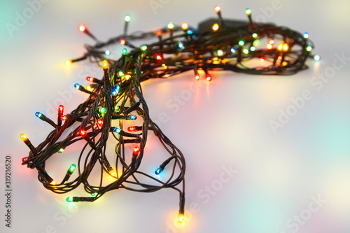 Colorful glowing Christmas lights. Holiday background. Party garland decoration on a white background. Studio shot