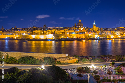 Rocky coastline of Malta and the architecture of Valletta city at night