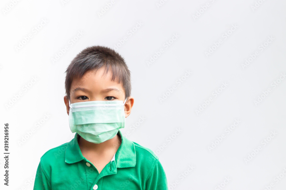 Asian child boy wearing a protection mask against PM 2.5 air pollution. On a white background. Environmental and healthy concept. Asian child boy wearing a protection mask against PM 2.5 air pollution. On a white background. Environmental and healthy concept.