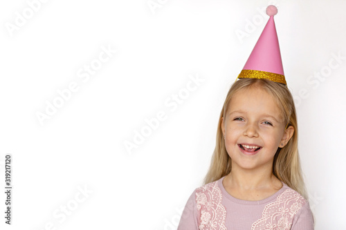 Small child in pink party hat on white background. Copy space, mockup, template