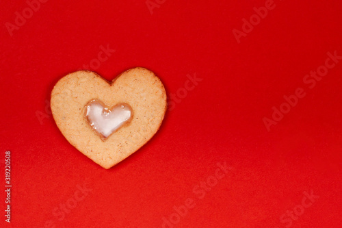 Cute handmade cookies in the shape of heart on red background. Concept of the Valentine's Day, surprises with love, holiday, etc. Flat lay, copy space.