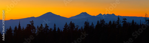 Colorful panoramic view after sunset with Mt Bachelor and Sisters Mountains near Bend in central Oregon.