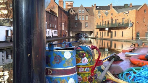 Bargeware at Gas Street Basin, Birmingham.  Camera move past traditionally painted bargeware on a barge moored at Gas Street Basin in Birmingham, England. photo