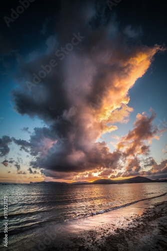 Dramatic sky over Alghero shore at sunset