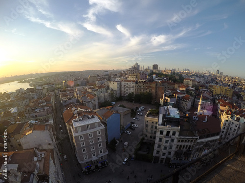Istanbul panoramic view from Galata tower top at sunset, buildings cars and roads under the blue sky photo