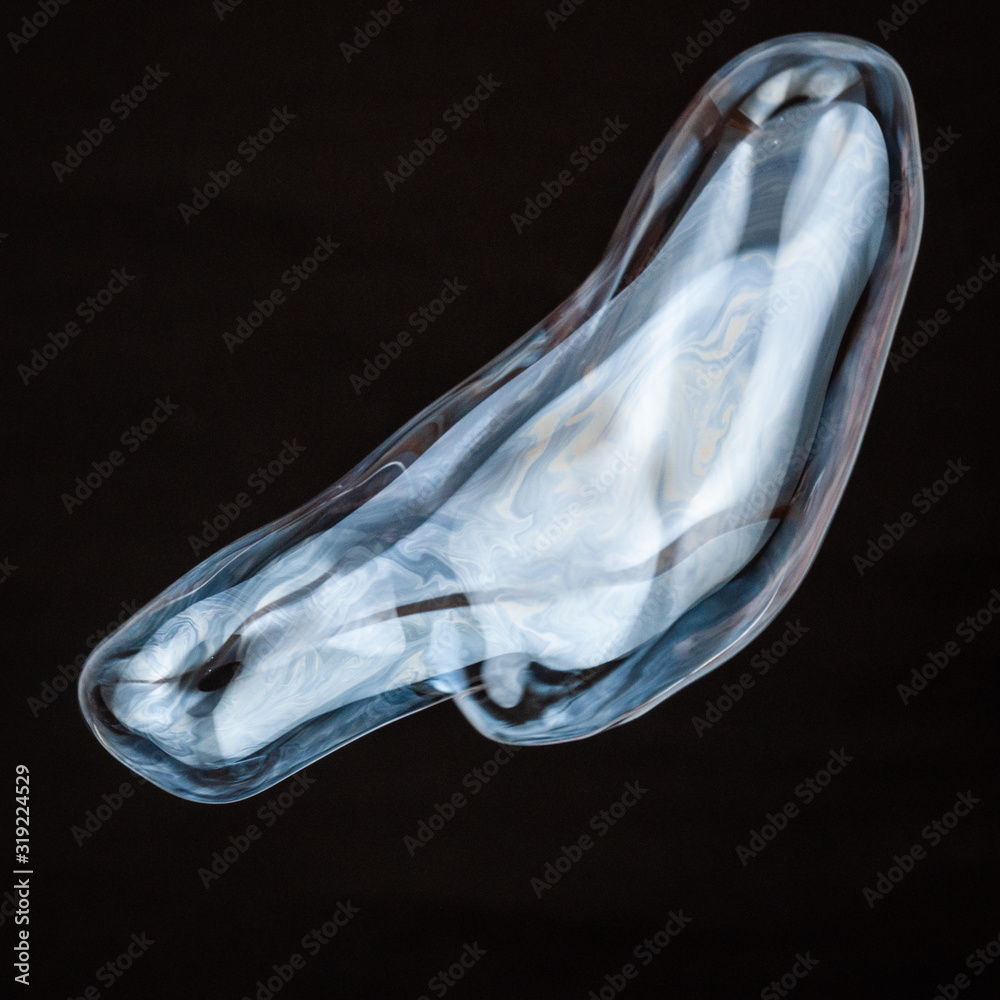 Naklejka premium Colorful creative amorphous soap bubble floating with a black background