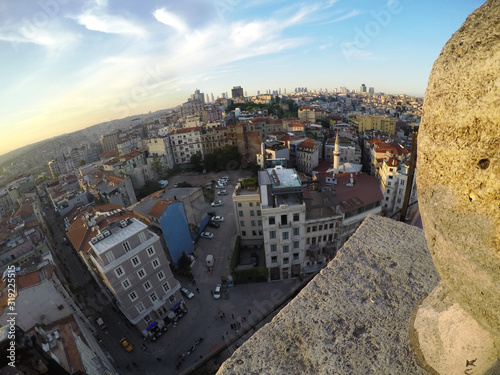 Beautiful view of Istanbul city from above Galata tower, buildings under blue sky at sunset photo