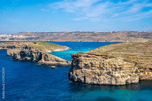 Stone cliffs on the blue lagoon of the island of Comino and Gozo Malta. Mediterranean Sea