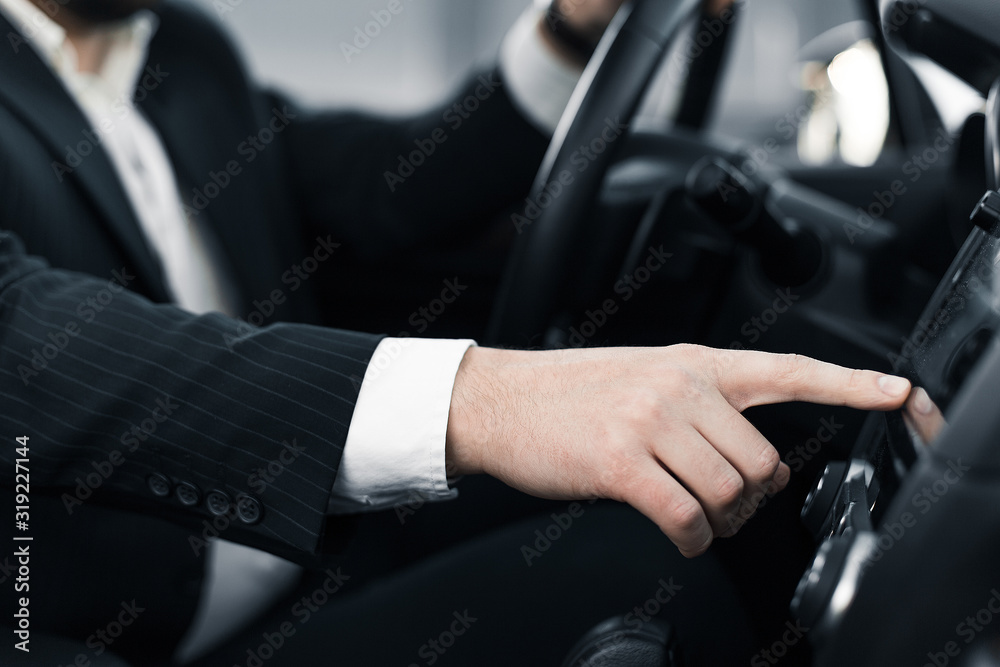 Handsome caucasian businessman driver inside in vehicle  with coffee and gadget and check mail and talking with partners