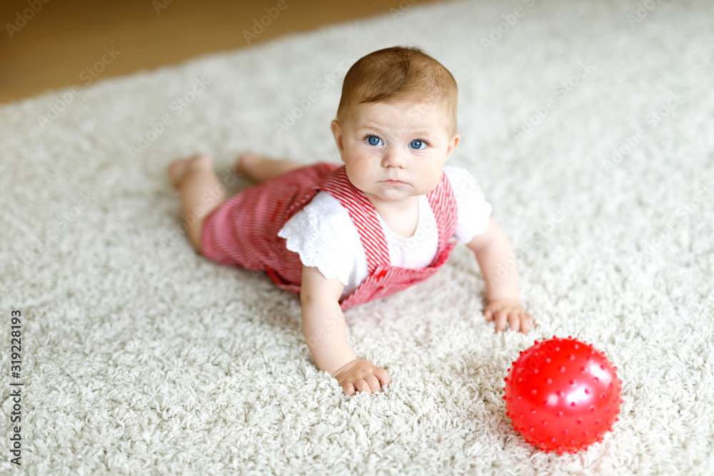 Cute baby girl playing with red gum ball. Cute baby girl playing with red gum ball.