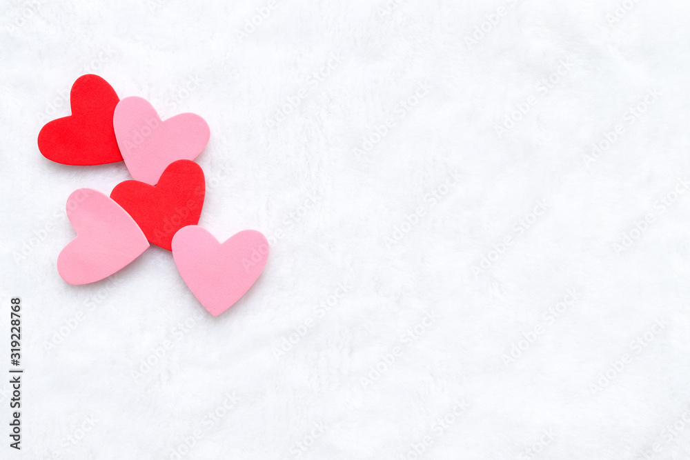 Red and pink hearts overlapping on a white background