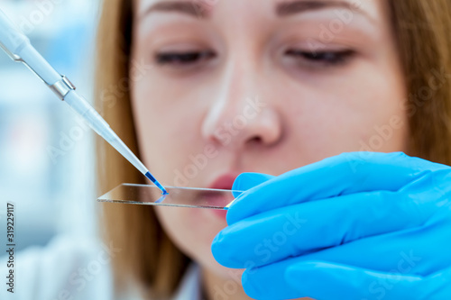 Girl lab technician at the clinic's microbiology laboratory